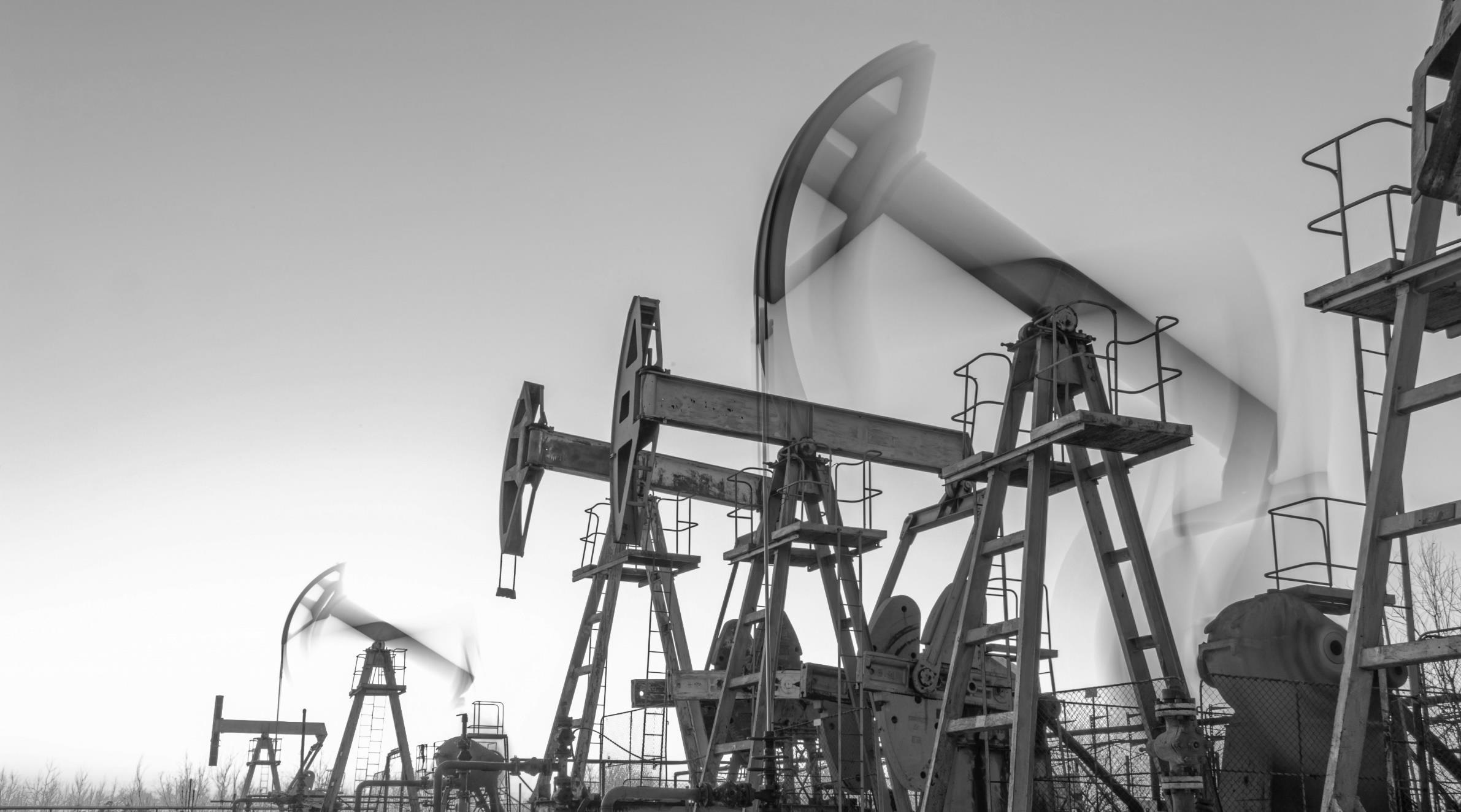 Oil pumpjacks in an industrial landscape